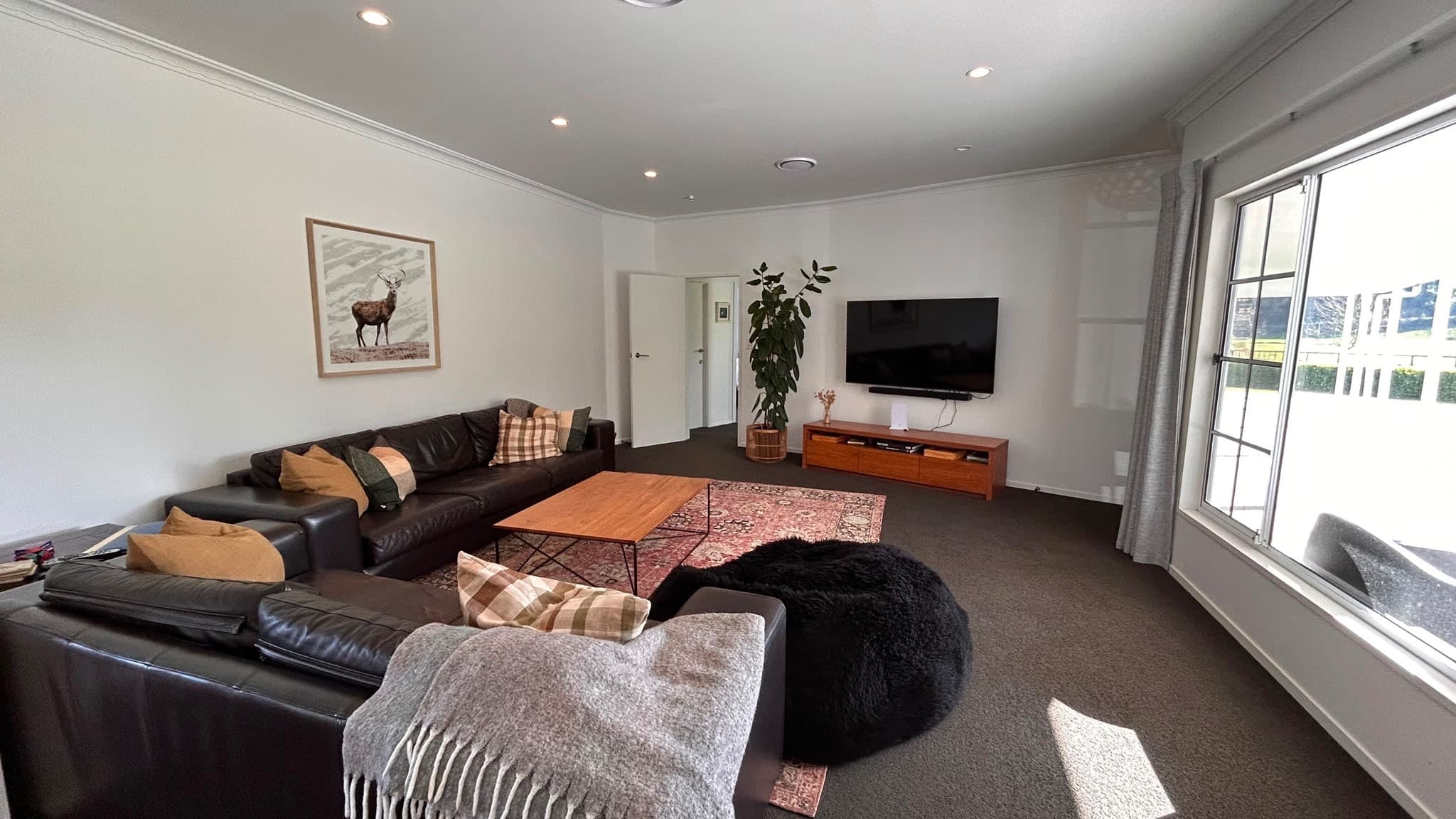 Spacious lounge with large television and Sky Sport